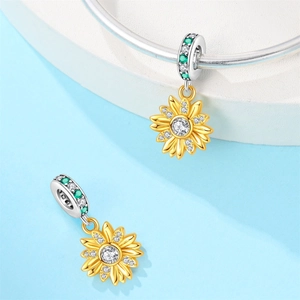 Detailed view of silver sunflower charm with gold petals and inlaid crystals for bracelets