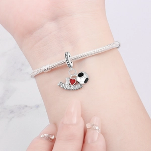Close-up of silver football charm bracelet with I Love Football heart and soccer ball charm
