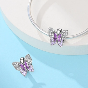 Detail of silver butterfly charm with purple enamel and zircons on a snake chain bracelet