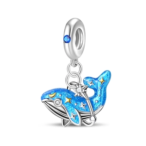 Macro view of whale charm with blue starry enamel and gold star details for bracelets