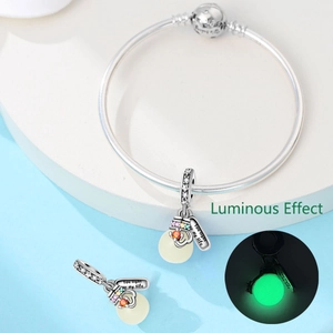 Silver charm bracelet with luminous light bulb pendant and 'You light up my life' tag