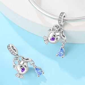 Aquarius theme sterling silver charm with purple gem and light blue teardrop stone
