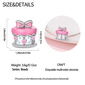 Macro view of pink enamel cake charm with silver bow and zirconia for DIY bracelets