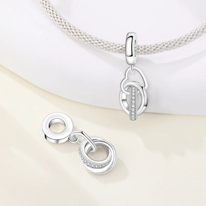 Makroaufnahme von Herzanhänger aus Silber mit Zirkonia an geflochtenem Armband