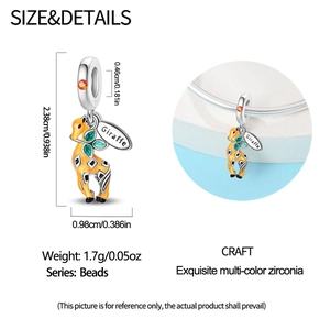 Detail view of giraffe charm with yellow enamel and orange zircon, showing dimensions