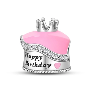 Detailed view of happy birthday cake charm with pink enamel, crown, and sparkling zircon stones