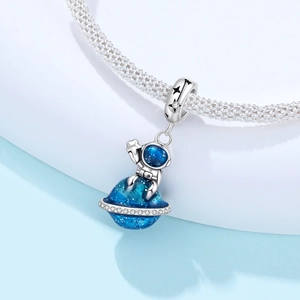 Nahaufnahme von Silber-Astronauten-Anhänger mit blauem Planeten und funkelnden Zirkonia-Details