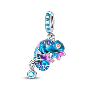 Macro shot of silver chameleon charm with colorful enamel and a blue gemstone drop