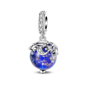 Macro view of blue glass charm with gold foil stars and silver crescent moon detail