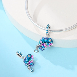 Close-up of chameleon charm with gradient enamel and sea blue zircon on silver bracelet