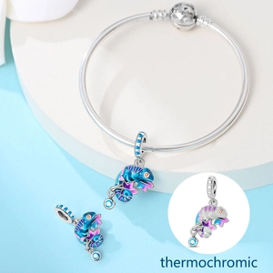 Macro detail of thermochromic chameleon charm with Together engraved on silver bracelet