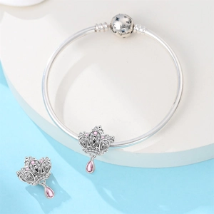 Detail of silver crown charms with pink crystals and We Belong Together engraved clasp