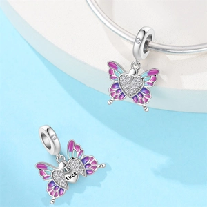 Macro shot of silver butterfly charm with purple enamel and LUCK engraving