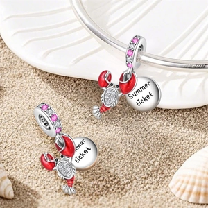 Detailed view of silver lobster charm with red enamel and Summer Ticket engraving