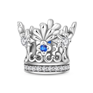 Detail of silver crown charm with blue gemstone and white zircon micro-inlay