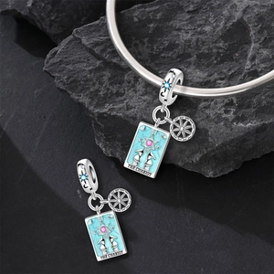 Detail of The Chariot tarot charm in silver with blue enamel and pink zircon stones