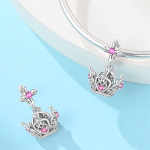 Detailed view of silver crown charm with pink heart zircon and sparkling crystal stones