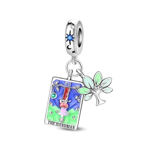 Macro detail of silver tarot charm with enamel Tree of Life and The Hanged Man engraving