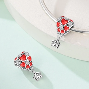 Hot air balloon charm with red enamel heart and zircon stones on a silver bracelet