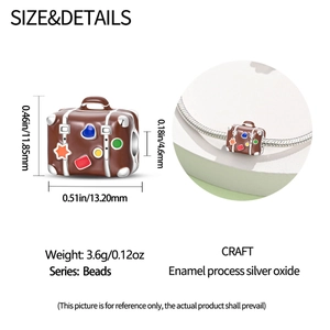 Macro view of silver vintage suitcase charm with colorful enamel details and dimensions