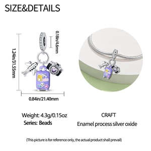 Travel charms detail showing silver airplane, purple suitcase and camera bead with zircon