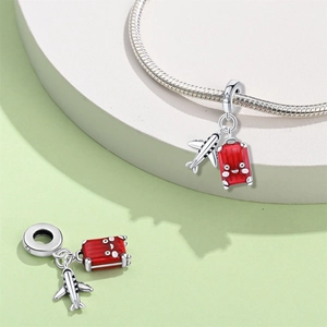 Macro view of airplane and red suitcase charm with S925 silver details for bracelets