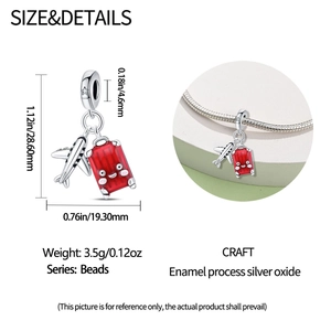 Detailed view of silver airplane and red enamel suitcase charm with size dimensions