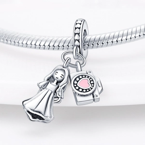 Macro view of silver charm featuring a cute girl and camera with a pink heart detail