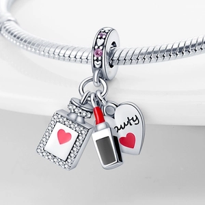 Silver charm dangle with perfume bottle, lipstick, and heart with Beauty engraving