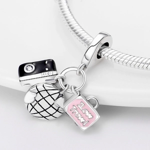 Detail of travel charms with black camera, pink suitcase and silver globe on snake chain
