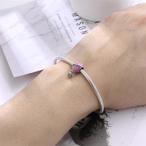 Silver snake chain bracelet with a romantic pink enamel hot air balloon charm on wrist