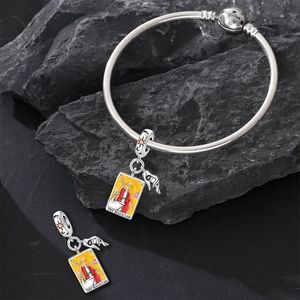 Close-up of The Magician tarot charm and silver bracelet with belong together engraving