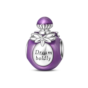 Macro shot of purple enamel perfume bottle charm with Dream boldly engraving for bracelets