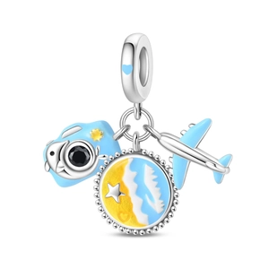 Macro detail of travel charms featuring blue camera, beach pendant and airplane dangle