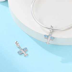 Macro detail of blue enamel silver airplane charm with zircon stars for DIY bracelets