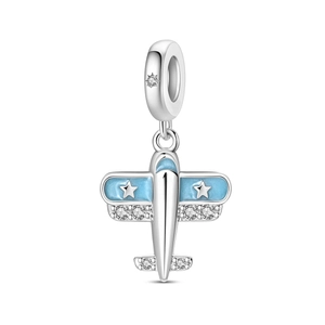 Macro detail of silver airplane charm with light blue enamel and sparkling zircon stars
