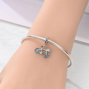 Close-up of silver bicycle charm with blue enamel wheels and READY GO engraving