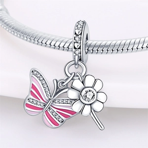 Macro detail of silver butterfly pendant with pink enamel and sparkling zircon stones