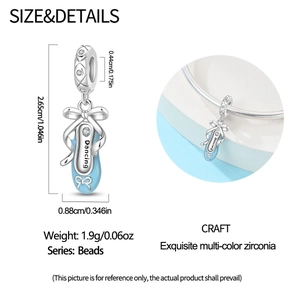 Detailed view of silver ballet shoe charm with blue enamel and Dancing engraving