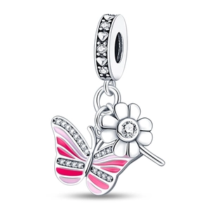 Macro detail of silver butterfly and flower charm with pink enamel and sparkling zircons