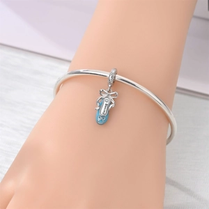 Silver bangle bracelet featuring a light blue ballet shoe charm with Dancing text