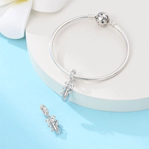 Detailed view of silver ballet shoes charm and bracelet with engraved lettering