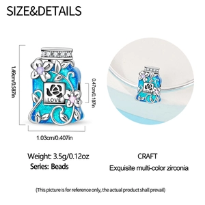 Macro view of blue enamel perfume bottle charm with silver flowers and Love engraving