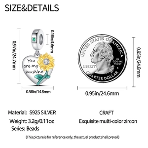 Detailed view of silver sunflower heart charm with measurements and coin for scale