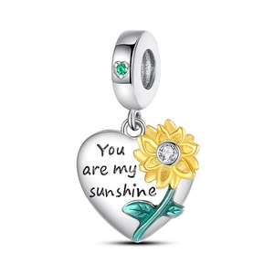 Detailed view of silver heart charm with sunflower and You are my sunshine engraving