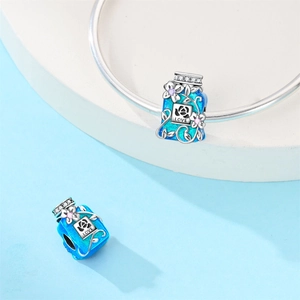 Detail of blue enamel perfume bottle charm with LOVE engraving on a silver bracelet