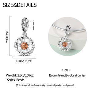 Detail view of silver sunflower charm with orange zirconia and floral vine engravings