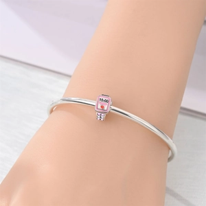 Detailed view of silver charm bracelet with a pink Apple Watch style charm and zircons