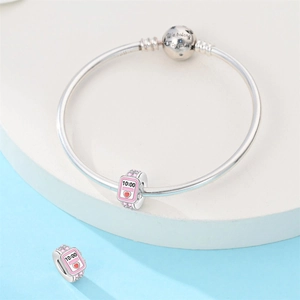 Detail of silver charm bracelet with 'We belong together' sphere and pink smartwatch charm