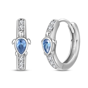 Detail of silver turtle earrings featuring blue teardrop stones and zircon accents